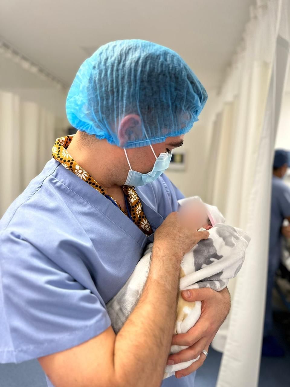 Father holding his newborn for the first time in the delivery room